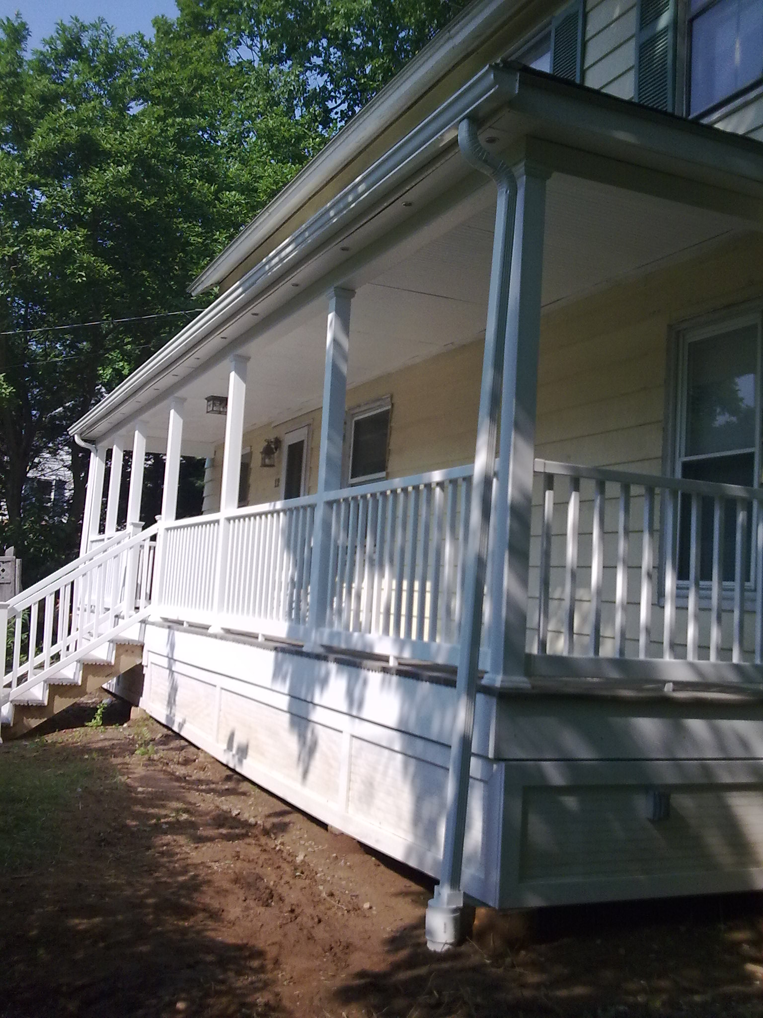 Complete new porch built from the ground up: foundation, stairs, railing, columns, roof and gutter system